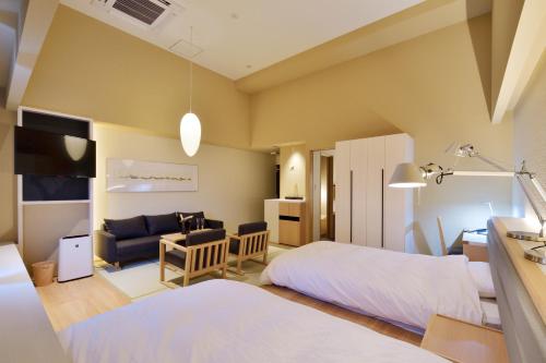 a bedroom with a bed and a living room at THE CHELSEA BREATH in Takamatsu