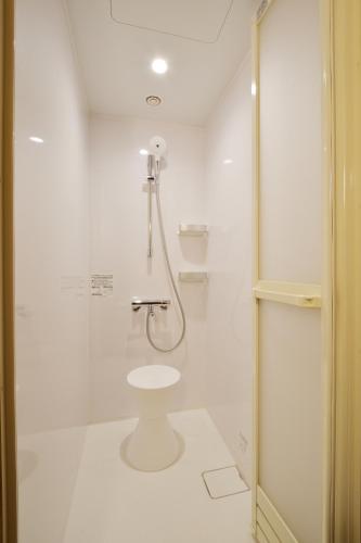 a white bathroom with a shower and a toilet at THE CHELSEA BREATH in Takamatsu