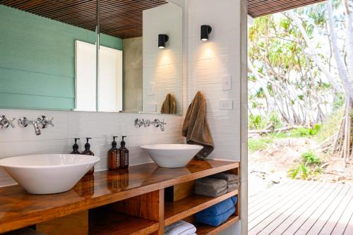 a bathroom with two sinks and a mirror at Wilson Island in Wilson Island