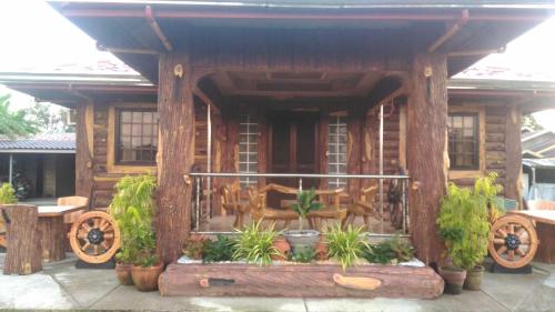 a small wooden house with plants in front of it at Vievan's transient house in Alaminos