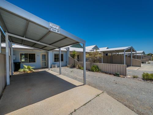 a building with a garage with a street sign on it at Seafront Unit 49 in Jurien Bay