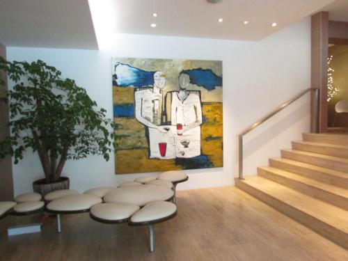 a room with stools and a painting on the wall at D'Hotel Singapore managed by The Ascott Limited in Singapore