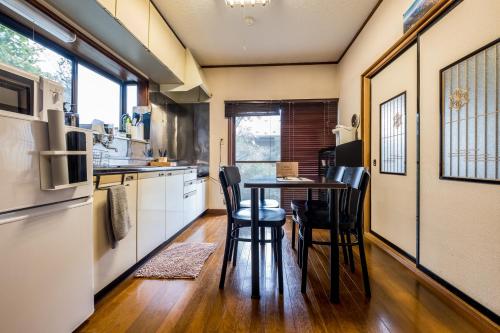 a kitchen with a table and chairs in a room at Classic Japan Living ASAMA in Fujikawaguchiko