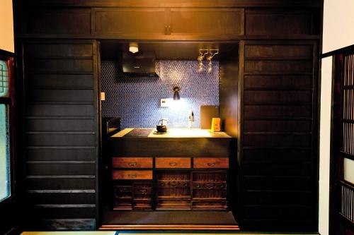 a bathroom with a sink and a counter at Tsuyukusa-an in Kyoto
