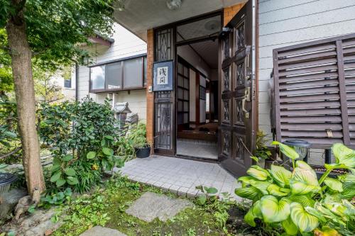 an entrance to a house with an open door at Classic Japan Living ASAMA in Fujikawaguchiko
