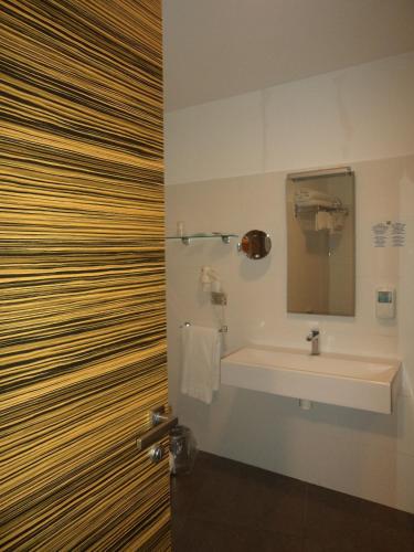 a bathroom with a sink and a shower with a mirror at ibis Styles Catania Acireale in Acireale