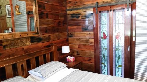 a bedroom with a bed and a stained glass window at Eagle Foundry Bed & Breakfast in Gawler