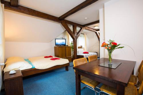 a bedroom with a bed and a table with flowers on it at Apartment Nedrik in Rokytnice nad Jizerou
