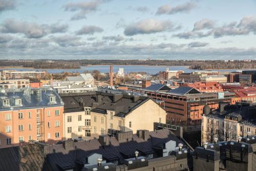a view of a city with a river and buildings at Noli Sörnäinen in Helsinki