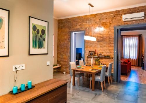 a dining room and living room with a table and chairs at SummerStreetSeven in Budapest