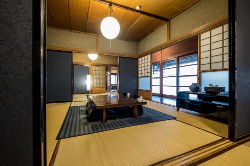 a living room with a wooden table and a television at Classic Japan Living Kikuya in Fujikawaguchiko