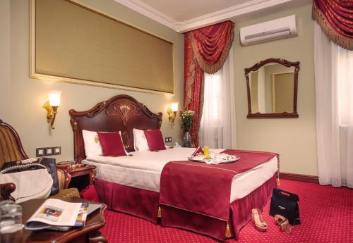 a hotel room with a large bed and a mirror at Staro Hotel in Kyiv