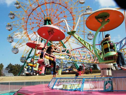 a ferris wheel with people on it at a carnival at APA Hotel Koriyama Ekimae in Koriyama