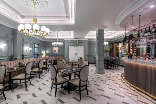 基勒纳德The Heritage的一家有桌椅和酒吧的餐厅