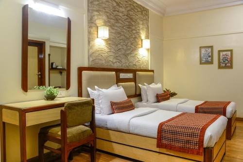 Postel nebo postele na pokoji v ubytování Hotel Ameya