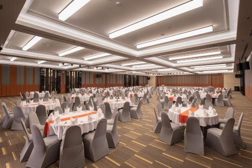 an image of a banquet hall with white tables and chairs at The Heritage Chiang Rai Hotel and Convention in Chiang Rai