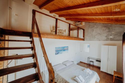 a bedroom with a staircase and a bed in a room at Stone house in Novi Velia