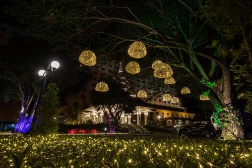 a house decorated with christmas lights at night at The Heritage Chiang Rai Hotel and Convention in Chiang Rai