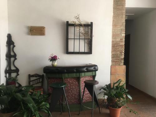 a bar in the corner of a room with plants at El Zaguan in Granada