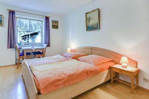 a bedroom with a bed and a dining table at Katharinenhof Wohnung Kramer (2) in Garmisch-Partenkirchen