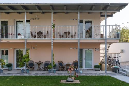 a house with chairs and tables on the balcony at Accommodation Baron in Ljubljana