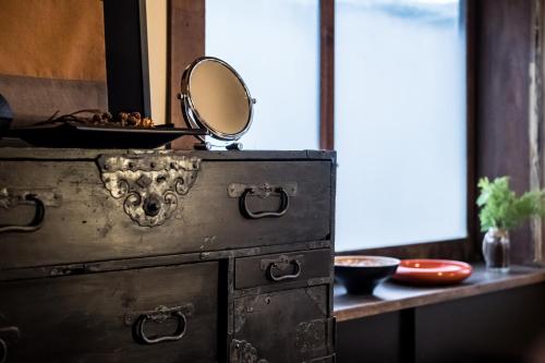 an old dresser with a mirror on top of it at Classic Japan Living Kikuya in Fujikawaguchiko