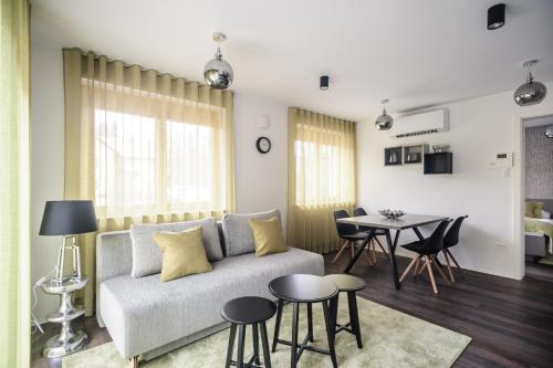 a living room with a couch and a table at Apartments Villa Tatiana in Bled