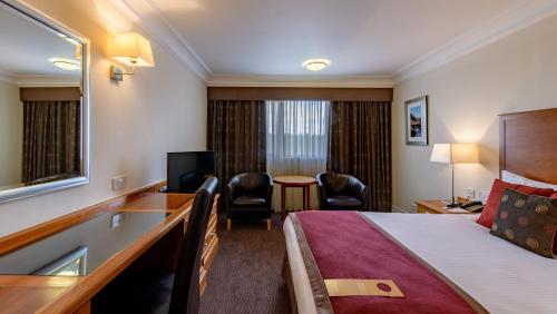 a hotel room with a bed and a desk at The Aberdeen Altens Hotel in Aberdeen