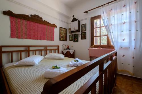 a bedroom with a bed with towels on it at Traditional Family Cretan Home! in Yerakianá
