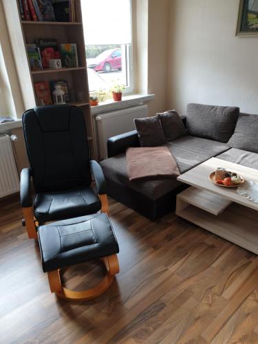 a living room with a couch and a chair at Ferienwohnung Wendehake in Quedlinburg