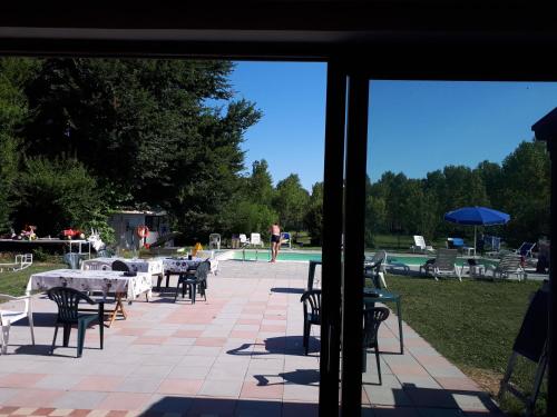 a view of a patio with tables and chairs and a pool at Biogarden in Zelarino