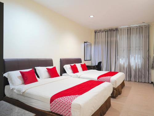 En eller flere senge i et værelse på Super OYO 89544 Utama Inn