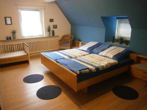 a bedroom with a large bed in a room at Ferienwohnung An der Schlier in Neuental