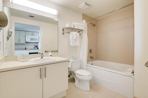 a bathroom with a sink and a toilet and a tub at Ocean View Balcony steps from Restaurants, Peacock Park & Marina in Miami