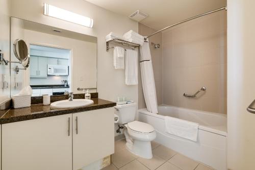 a bathroom with a toilet and a sink and a tub at Ocean View Balcony steps from Restaurants, Peacock Park & Marina in Miami