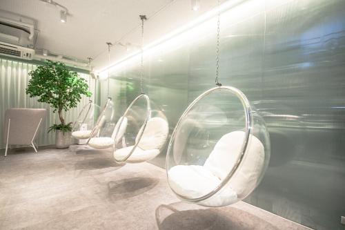 a row of white chairs in a waiting room at Hotel Vista in Pattaya Central