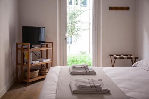 a bedroom with a bed with two towels on it at Pietrapiana34 Boutique Apartments in Florence