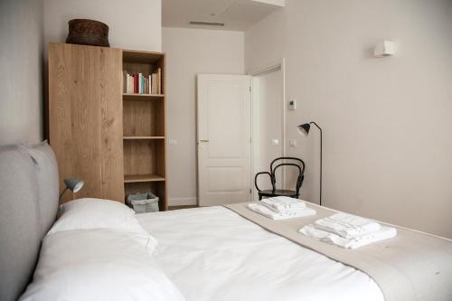 a bedroom with a white bed with two towels on it at Pietrapiana34 Boutique Apartments in Florence
