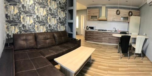 a living room with a couch and a kitchen at Апартаменти Маяк in Odesa