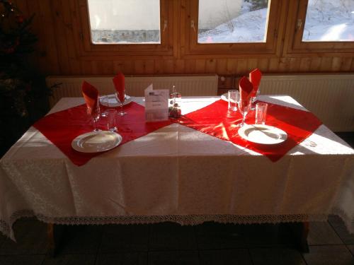 a table with a red and white table cloth on it at Cabana Dara in Cumpăna