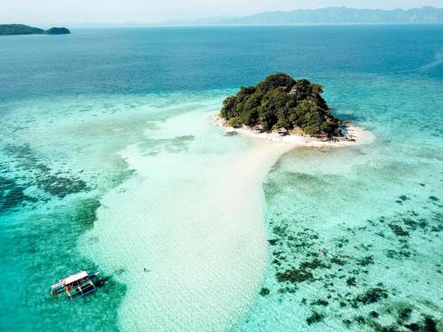 an island in the middle of the ocean at Dayon Hostel in Coron