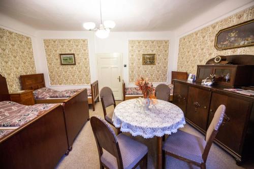 a room with a table and chairs and a bedroom at Penzion hradu Svojanov in Svojanov
