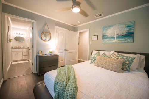 a bedroom with a bed and a dresser in it at Walk to the Silos! 3 Bed 1960's Bungalow near Baylor in Waco