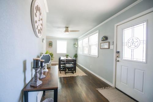 a hallway with a door and a dining room with a table at Walk to the Silos! 3 Bed 1960's Bungalow near Baylor in Waco