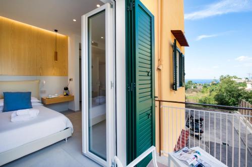 a room with a balcony with a bed and a window at Maison Manfredi Sorrento in Sorrento