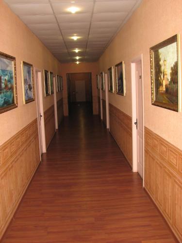 an empty hallway with paintings on the walls at Art Hotel in Izmail