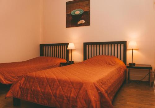 a bedroom with two beds and a painting on the wall at Terres de France - Moncontour Active Park in Moncontour-de-Poitou