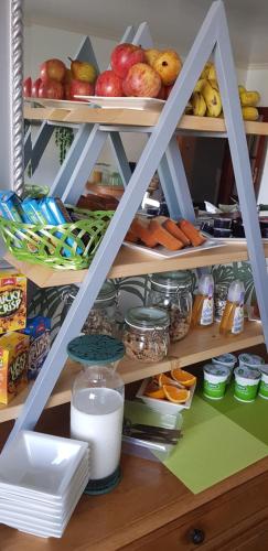 a shelf with food and other food items on it at B&B "Villa Alegria", Tarrafal in Tarrafal