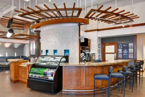 a restaurant with a bar with stools around it at Hyatt Place Birmingham/Hoover in Hoover
