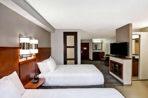 a hotel room with two beds and a flat screen tv at Hyatt Place Birmingham/Hoover in Hoover